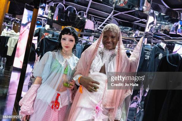 Jace May and Tomique pose with Merchandising at the Beyoncé Exclusive Renaissance Flagship Store on December 1, 2023 in London, England.
