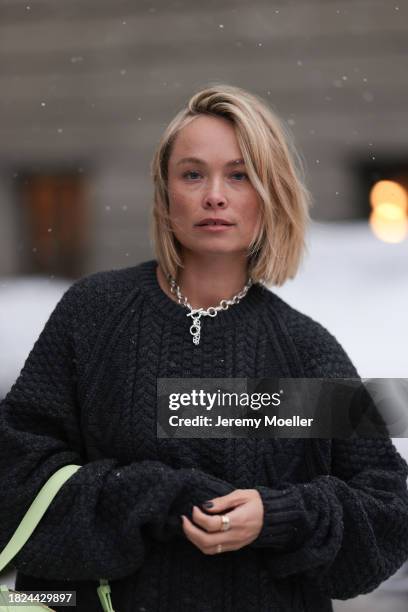 Nadine Berneis seen wearing Black Palms the label black wool cable knit sweater, silver earrings, Glambou silver chain necklace, Bottega Veneta light...