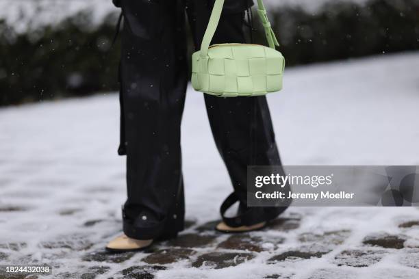 Nadine Berneis seen wearing Black Palms the label grey wool cable knit sweater, Young Poets black cargo pants, Bottega Veneta light green / pastel...