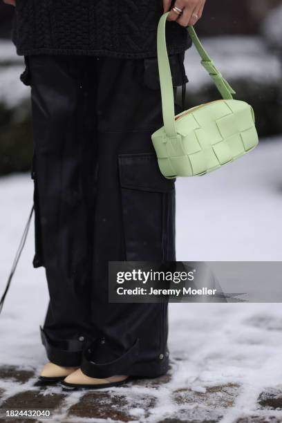 Nadine Berneis seen wearing Black Palms the label grey wool cable knit sweater, Young Poets black cargo pants, Bottega Veneta light green / pastel...