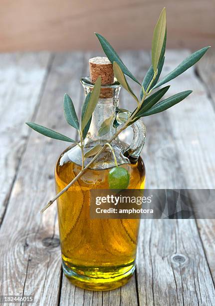 close-up of a bottle of olive oil - oil bottle stock pictures, royalty-free photos & images