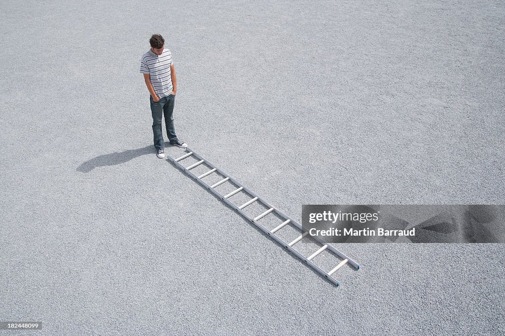 Man standing outdoors near ladder