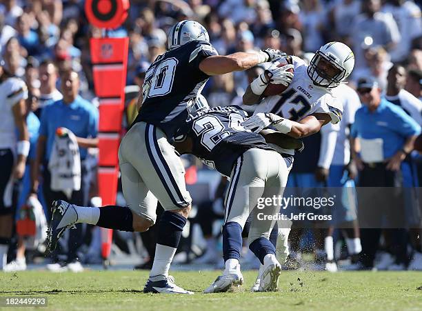 Wide receiver Keenan Allen of the San Diego Chargers is tackled by cornerback Morris Claiborne of the Dallas Cowboys after a reception, as middle...