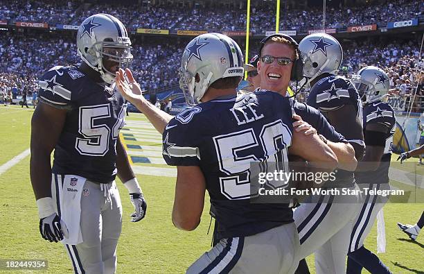 Dallas Cowboys head coach Jason Garrett hugs middle linebacker Sean Lee , after he ran back an interception for a touchdown against the San Diego...