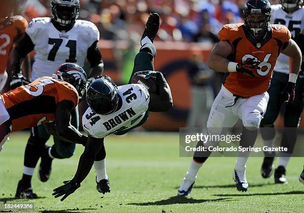 Denver Broncos safety Duke Ihenacho, left, takes down Philadelphia Eagles running back Bryce Brown during game action at Sports Authority Field in...