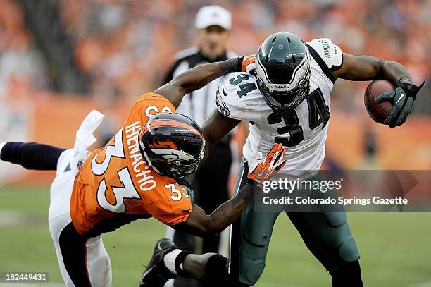 Denver Broncos safety Duke Ihenacho pushes Philadelphia Eagles running back Bryce Brown out of bounds during game action at Sports Authority Field at...