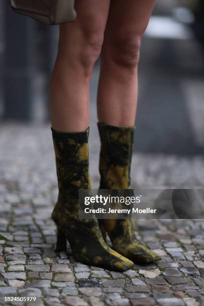 Nadine Berneis seen wearing Miista black / yellow batik pattern leather boots, on November 29, 2023 in Berlin, Germany.
