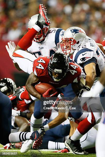 Jason Snelling of the Atlanta Falcons dives for a first down against the New England Patriots during the game at Georgia Dome on September 29, 2013...
