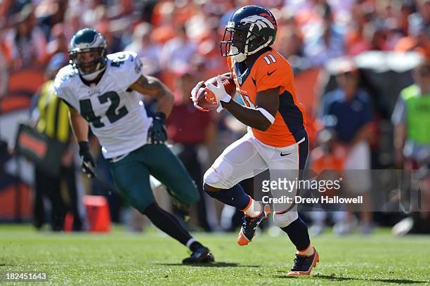 Trindon Holliday of the Denver Broncos returns a kick for a touchdown past Kurt Coleman of the Philadelphia Eagles at Sports Authority Field at Mile...