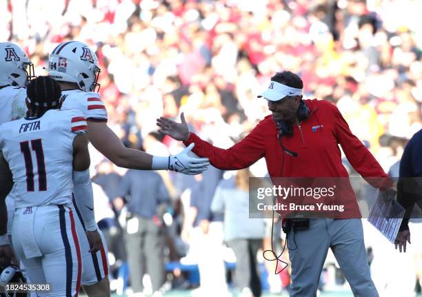 Head Coach of the University of Arizona Wildcats Jedd Fisch congratulates his players after a touchdown score during the University of Arizona...