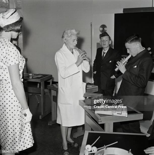 Music therapist Priscilla Barclay at work with two patients, one of whom is playing a bamboo pipe he has made himself, at St. Lawrence's Hospital,...