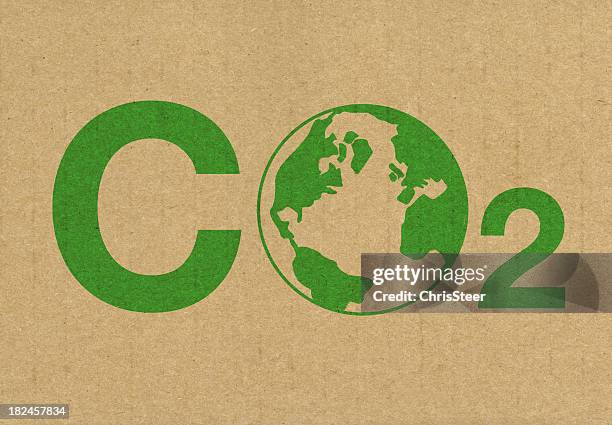 a green co2 logo on a brown cardboard background - co2 stock pictures, royalty-free photos & images