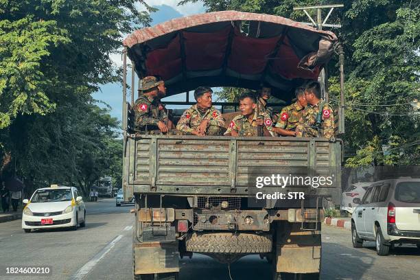 This photo taken on December 4, 2023 shows member of Myanmar's military patrolling on a truck down a street in Yangon.