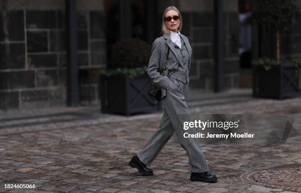 Marlies Pia Pfeifhofer seen wearing brown oval sunglasses, silver earrings, white cotton buttoned blouse / shirt, Dior black / white herringbone...