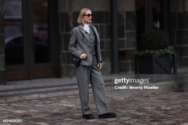 Marlies Pia Pfeifhofer seen wearing brown oval sunglasses, silver earrings, white cotton buttoned blouse / shirt, Dior black / white herringbone...