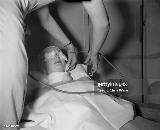 Beautician spraying oxygen onto a client's face during oxylation treatment at Helena Rubinstein's London salon, April 1948.