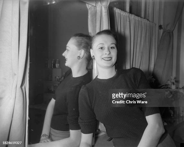 Woman smiling after undergoing a beauty treatment at Helena Rubinstein's London salon, April 1948.