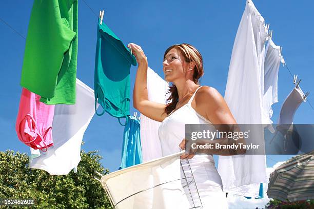 young woman hanging up laundry - washing line stock pictures, royalty-free photos & images