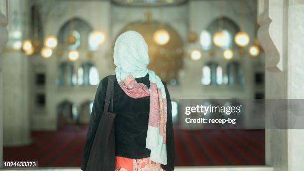 multiracial female tourist visiting and walking in mosque - daily life in ankara stock pictures, royalty-free photos & images