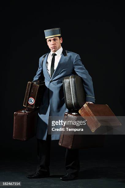 this is heavy! bellboy - vintage luggage stock pictures, royalty-free photos & images