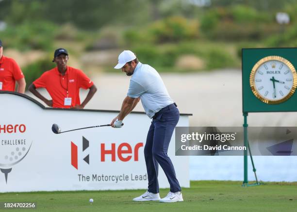 This image is part of a swing sequence; Scottie Scheffler of The United States plays his tee shot on the 18th hole during the first round of the Hero...
