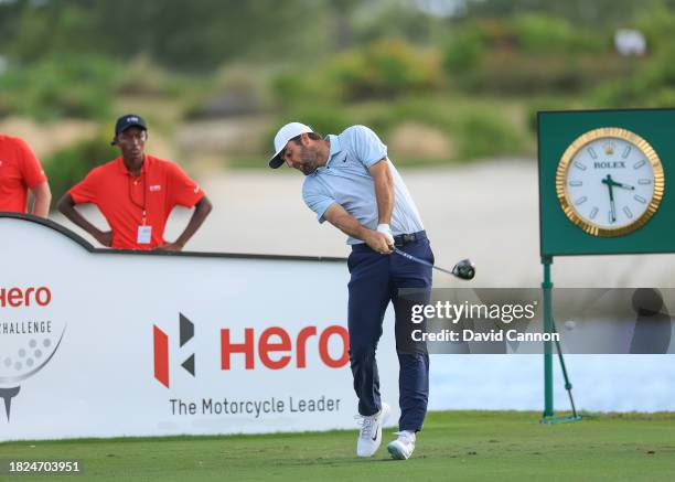 This image is part of a swing sequence; Scottie Scheffler of The United States plays his tee shot on the 18th hole during the first round of the Hero...