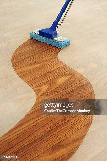 sponge mop cleaning a path across  dusty floor - clean floor stock pictures, royalty-free photos & images