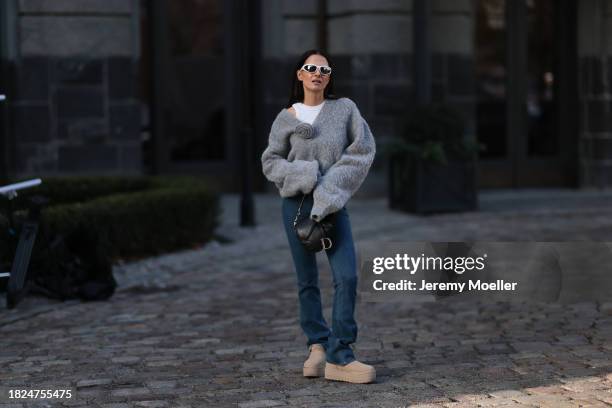 Anna Winter seen wearing Bottega Veneta white sunglasses, white cotton top, Rotate grey wool knit v-neck sweater / pullover with a flower detail,...