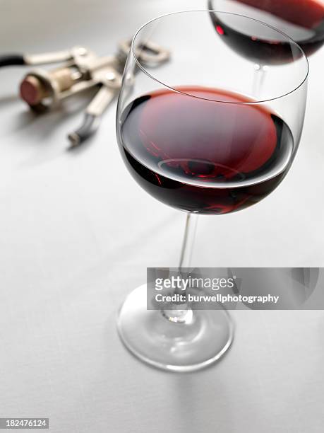 two red wine glasses with cork screw - wine cork stockfoto's en -beelden