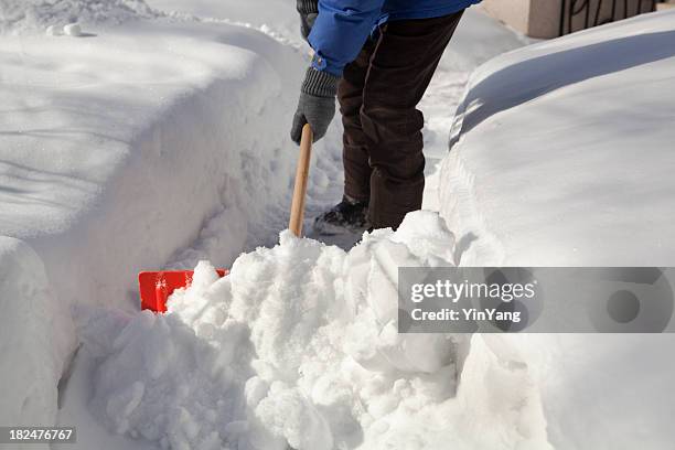 shoveling removing snow at residential home after winter blizzard storm - shoveling snow stock pictures, royalty-free photos & images