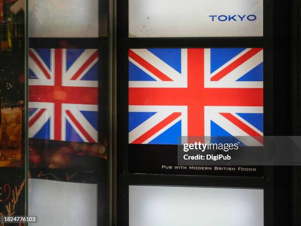 british pub sign with national flag at night in tokyo - british flag icon stock pictures, royalty-free photos & images