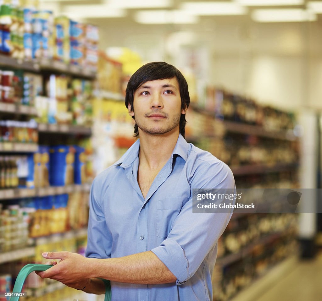 Young man shopping at the supermarket