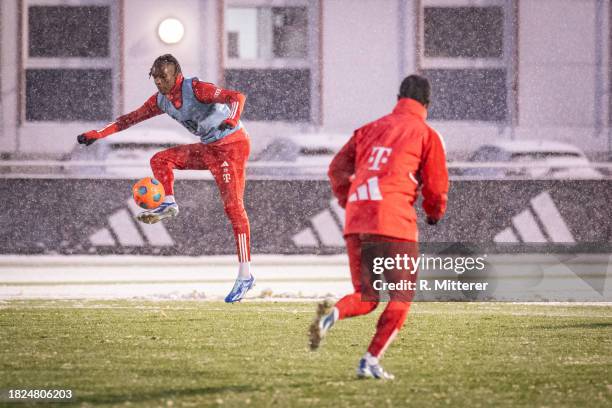 Mathys Tel of FC Bayern Muenchen jumps while he kicks the ball during a training session on December 01, 2023 in Munich, Germany.