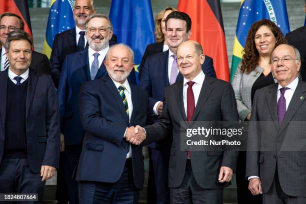 German Chancellor Olaf Scholz and Brazilian President Luiz Inacio Lula da Silva are posing for a family photo with the members of their governments...