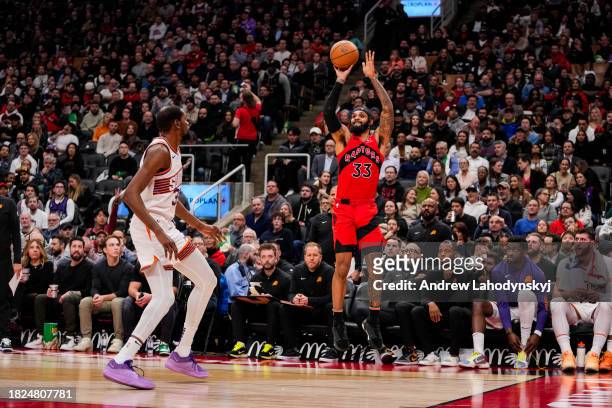 Gary Trent Jr. #33 of the Toronto Raptors shoots the ball against Kevin Durant of the Phoenix Suns during NBA action at the Scotiabank Arena on...