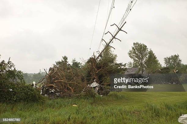 tornado damage with downed power line - knocked down stockfoto's en -beelden