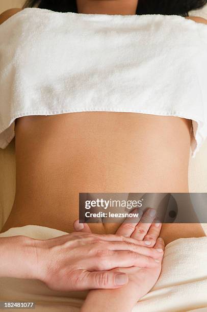 woman receiving lymphatic massage on abdomen - pubis stock pictures, royalty-free photos & images