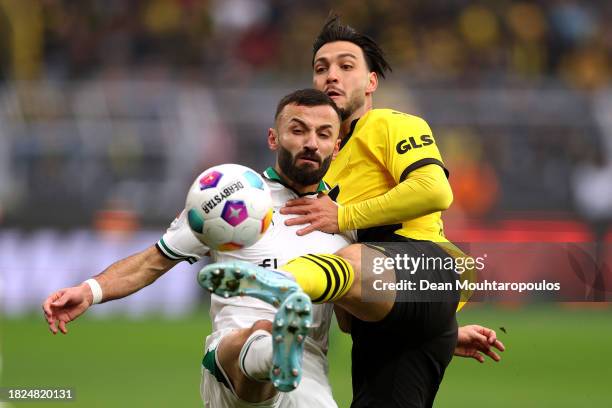 Franck Honorat of Borussia Moenchengladbach and Rami Bensebaini of Borussia Dortmund battle for the ball during the Bundesliga match between Borussia...