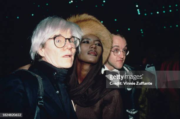 American artist Andy Warhol, Jamaican model and singer Grace Jones, and American artist Keith Haring attend an American Foundation for AIDS Research...