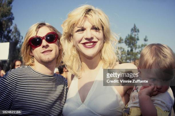 American singer, songwriter and musician Kurt Cobain, and his wife, American singer, songwriter, musician and actress Courtney Love, who holds their...