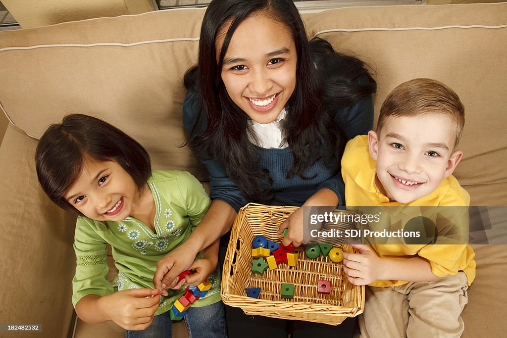 Babysitter with Two Happy Children