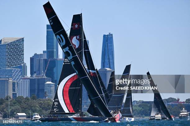Andoo Comanche competes with other boats during the SOLAS Big Boat Challenge race in the harbour in Sydney on December 5, 2023. / -- IMAGE RESTRICTED...