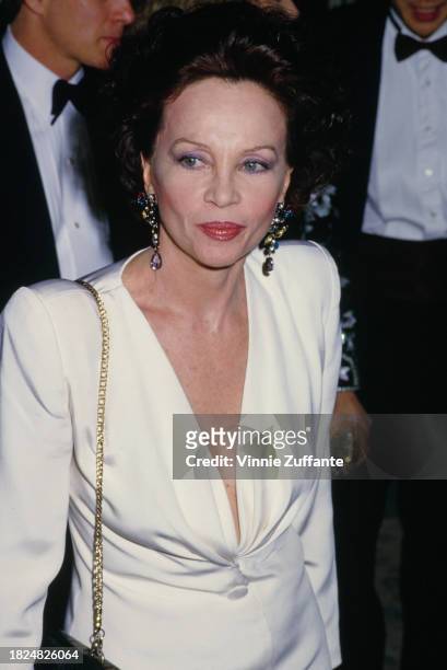 French-American actress and dancer Leslie Caron, wearing a white outfit with a plunging neckline, 5th Annual American Cinema Awards, held at the...