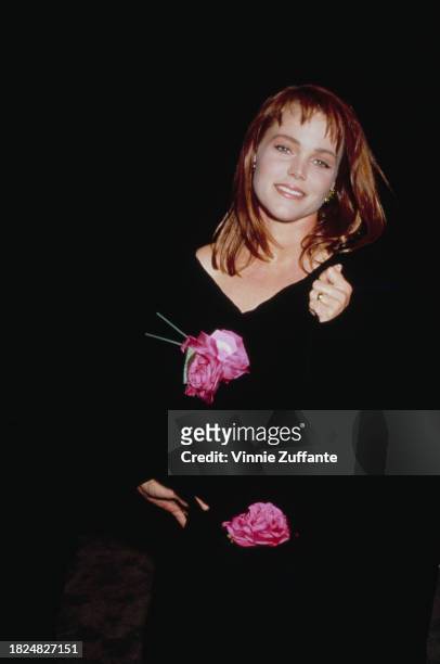 American singer and songwriter Belinda Carlisle, wearing a black v-neck outfit with floral decoration, attends the cocktail reception celebrating...