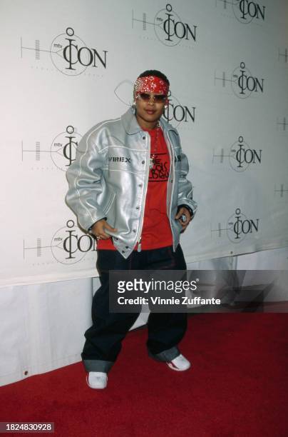 American rapper Da Brat, wearing a silver Avirex jacket over a red t-shirt, with baggy jeans, and a red bandana, attends the recording of the...