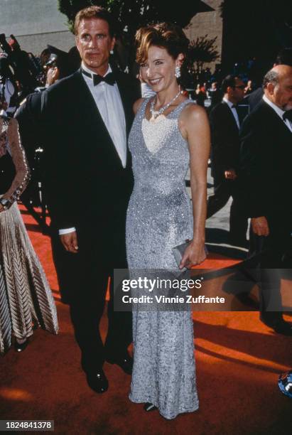 American actor Ted Danson, wearing a tuxedo and bow tie, and his wife, American actress Mary Steenburgen, who wears a silver evening gown attend the...