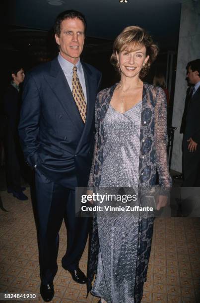 American actor Ted Danson, wearing a dark blue suit, and his wife, American actress Mary Steenburgen, who wears a silver dress with a sheer coat,...