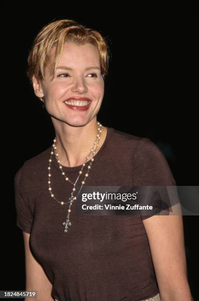 American actress Geena Davis wearing a brown cap-sleeved t-shirt, with a pearl necklace and a crucifix pendant, attends the Hollywood premiere of 'In...