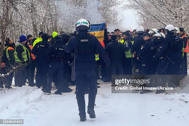 Police officers are on duty near Ukrainian truck drivers, blocked by Polish protesters near the Polish Ukrainian border crossing Korczowa, during a...