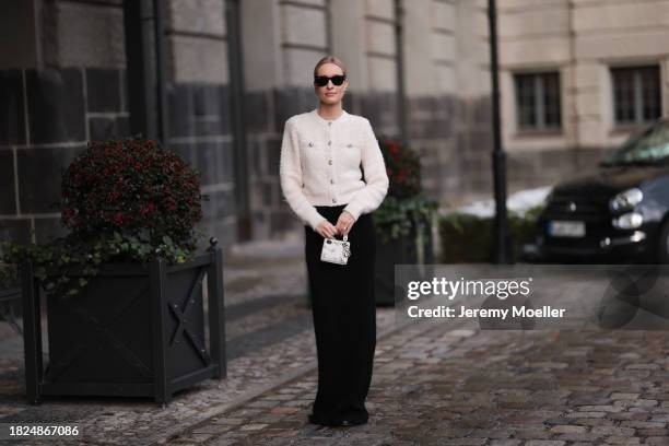 Marlies Pia Pfeifhofer seen wearing Ray-Ban Wayfarer black sunglasses, Vintage Dior gold statement earrings, H&M cream white boucle cardigan jacket,...